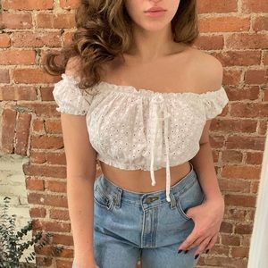 White babydoll eyelet top. You can wear off the shoulder or on